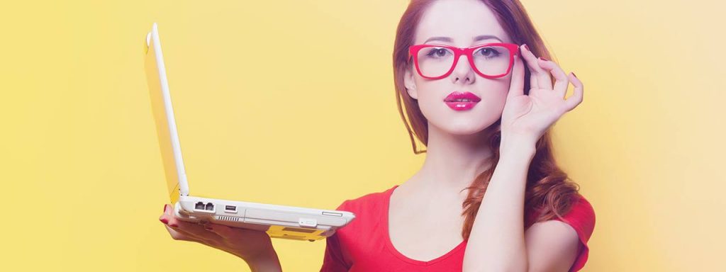 a-woman-holding-a-laptop-red-glasses-1024x384-1